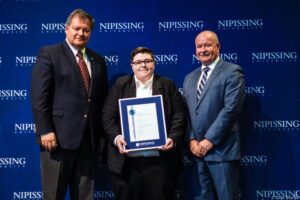 Dave Marshall Leadership Awards photo of a recipient or guests in front of a Nipissing University backdrop