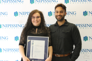 Guests and award recipients at the Dave Marshall Leadership Awards reception, posing in front of a Nipissing University backdrop