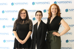 Guests and award recipients at the Dave Marshall Leadership Awards reception, posing in front of a Nipissing University backdrop