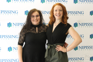 Guests and award recipients at the Dave Marshall Leadership Awards reception, posing in front of a Nipissing University backdrop