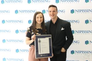 Guests and award recipients at the Dave Marshall Leadership Awards reception, posing in front of a Nipissing University backdrop
